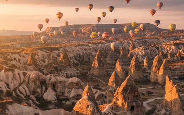 Flying over Cappadocia with Skies full of Hot Air Balloons